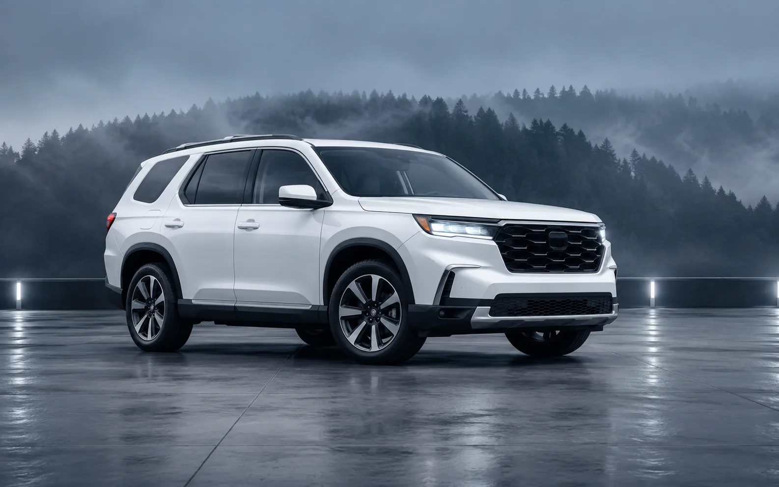 White three-row SUV in a mountain studio
